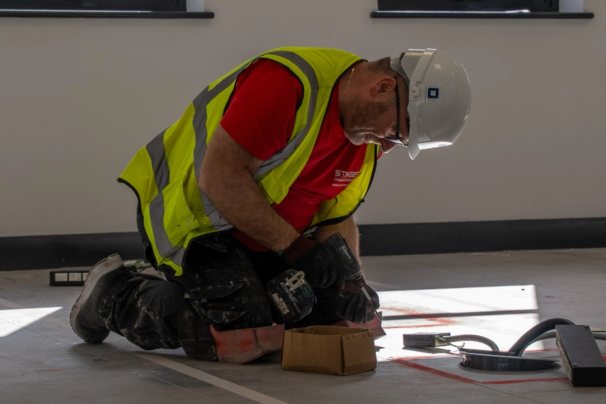 Raised access flooring contractor installing floor components on a commercial site